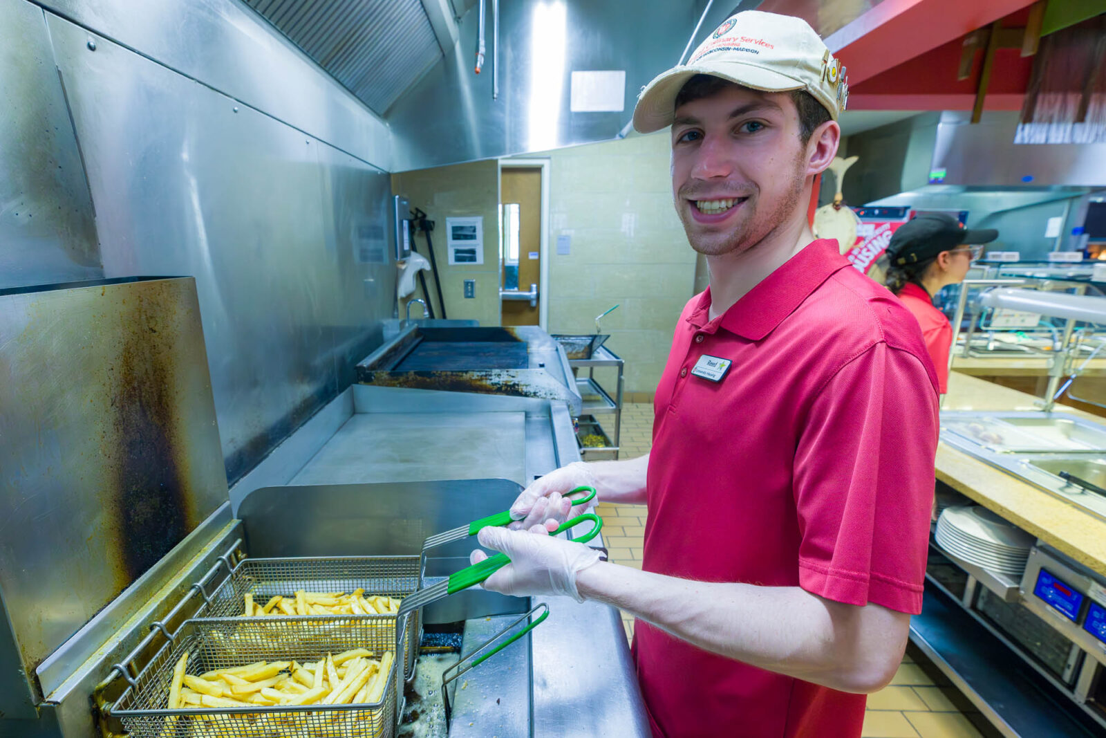 Reed drops fries into oil for frying at Carson's Market.