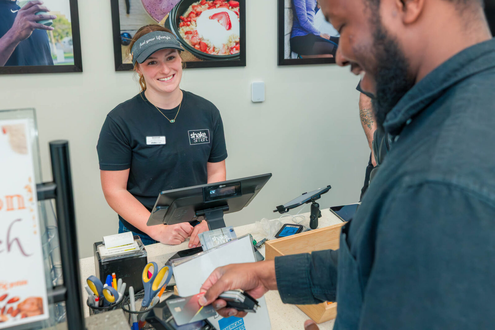 Savannah smiles as a customer checks out at Shake Smart in the Bakke Recreation & Wellbeing Center.