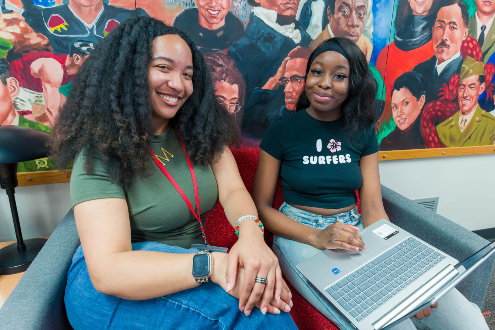 Milan helps a student with an application on a computer in the Center for Cultural Enrichment (CCE) within Witte Residence Hall.