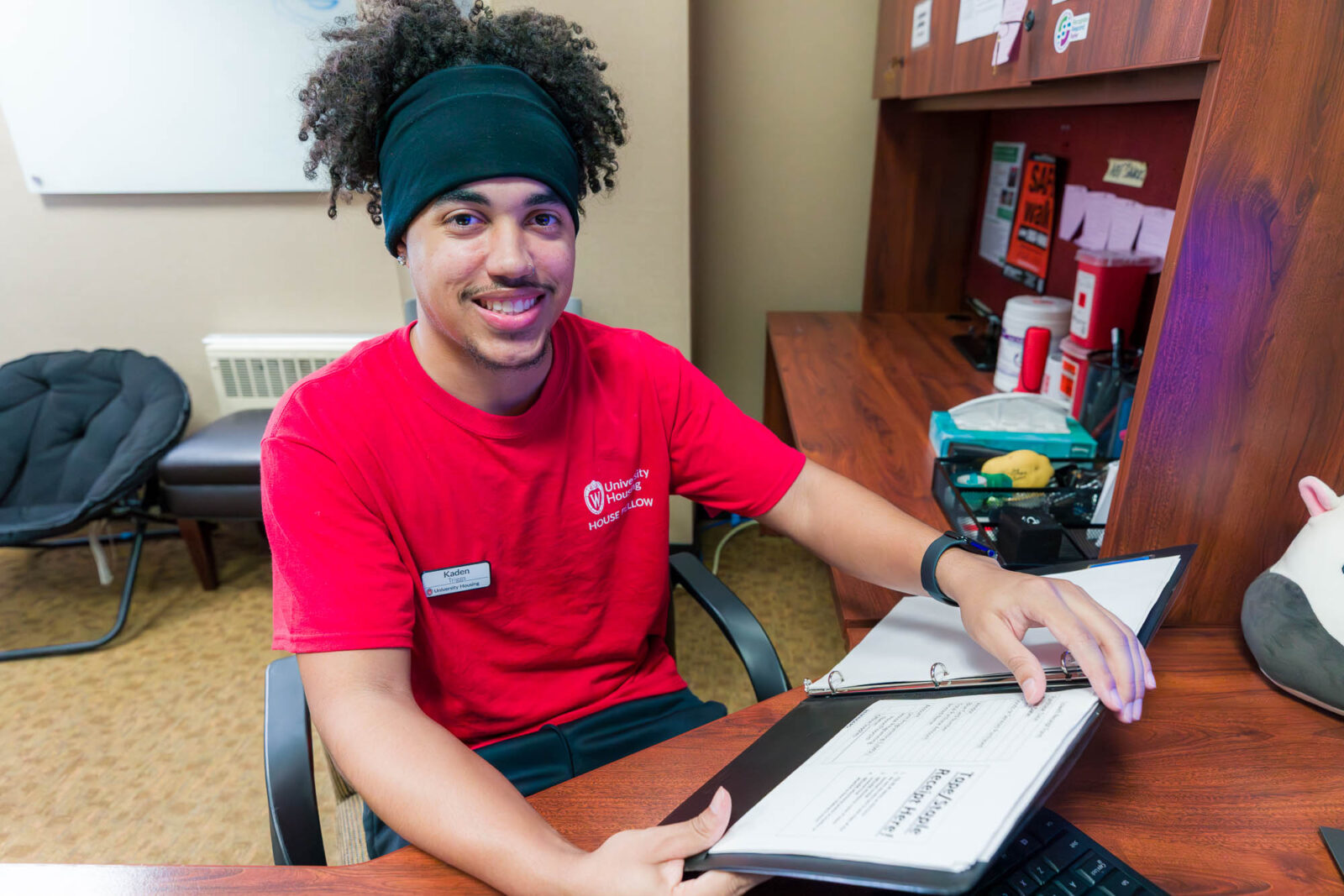 Kaden reviews information in the Residence Life Office (RLO) in Lowell Center.