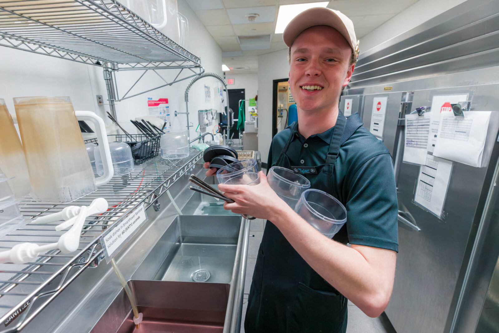 Tyler carries containers at Starbucks in Smith Residence Hall.