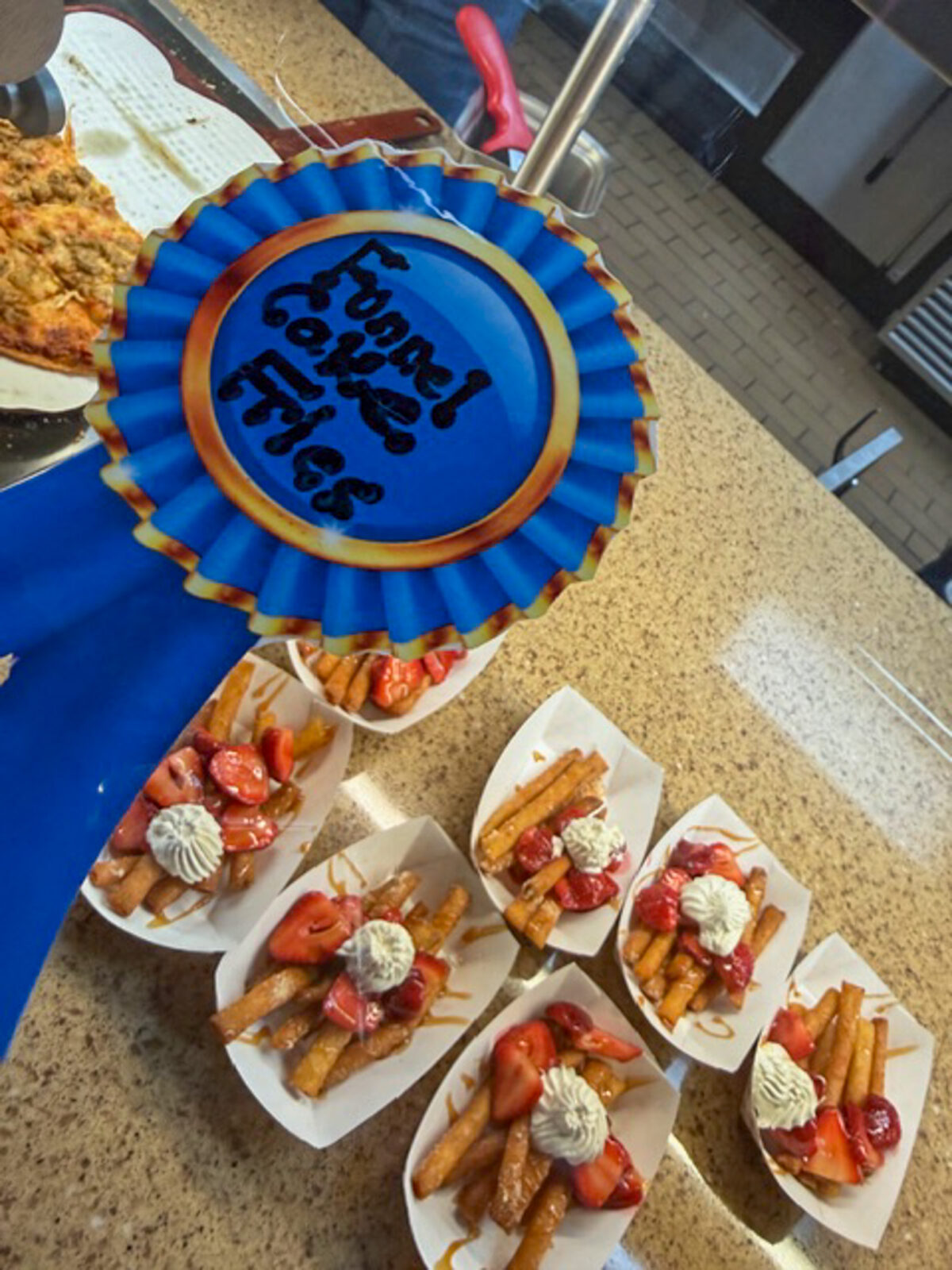 Blue ribbon with funnel cake fries at the Fair Day event