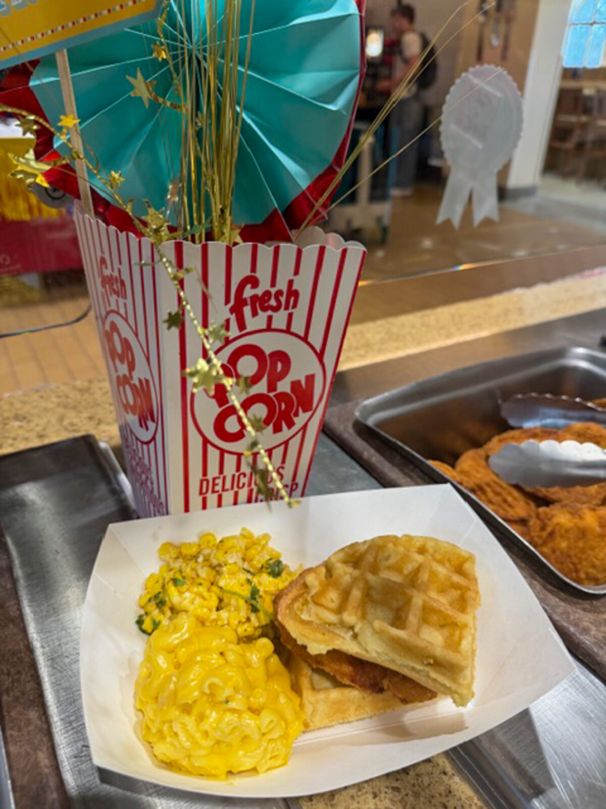 Plate with chicken and waffles, mac & cheese, and elote corn at the Fair Day event
