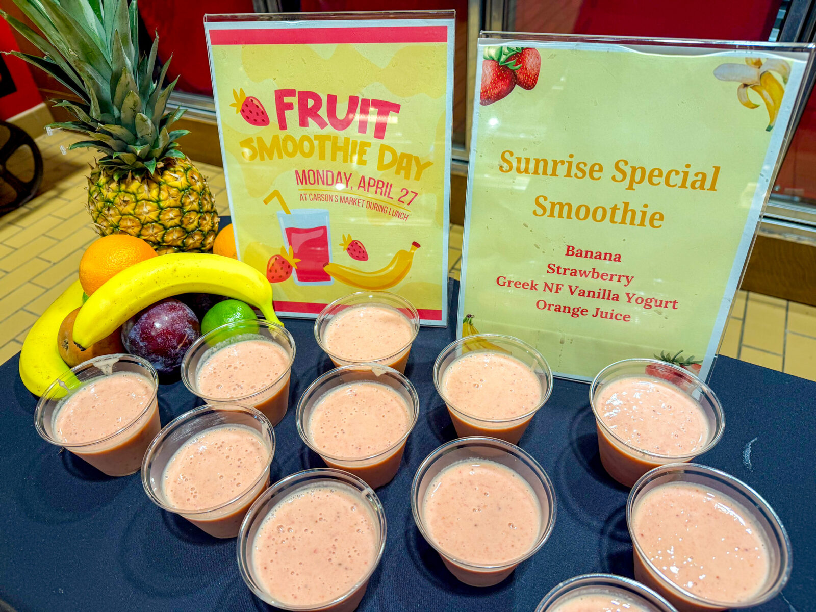 Sunrise Special Smoothie sign and small cups lined up for Fruit Smoothie Day