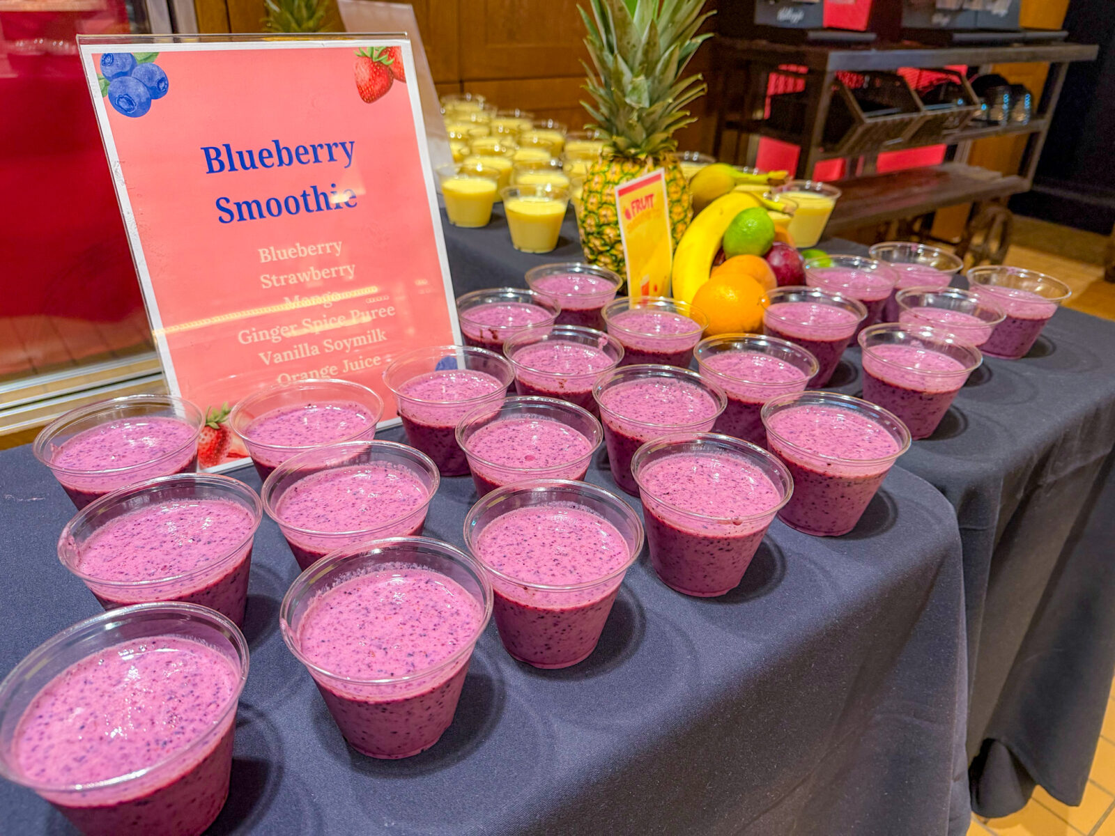 Blueberry Smoothie sign and small cups lined up for Fruit Smoothie Day