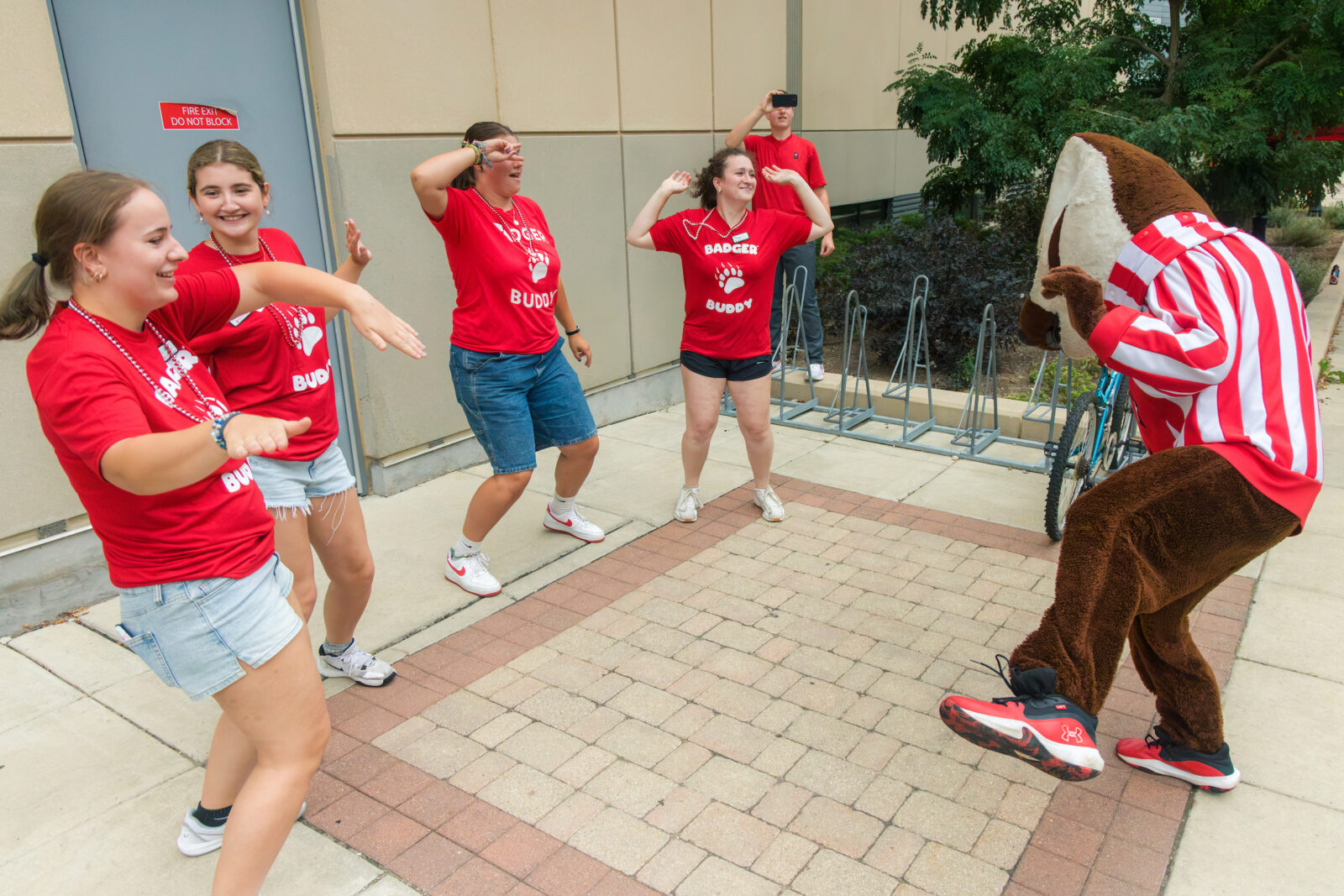 Bucky Badger and four Badger Buddies dancing