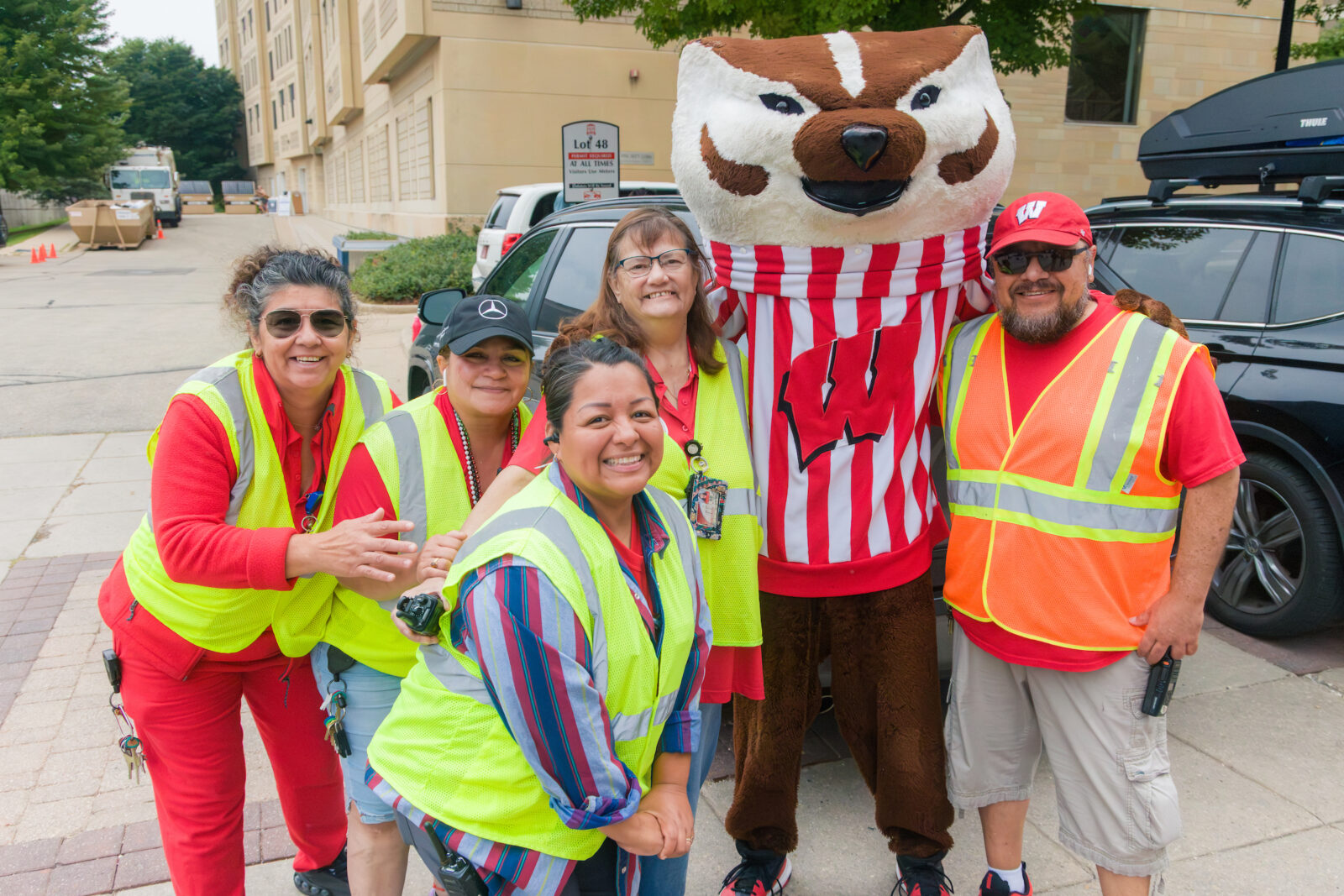 Bucky Badger poses with Housing Facilities staff helping with parking
