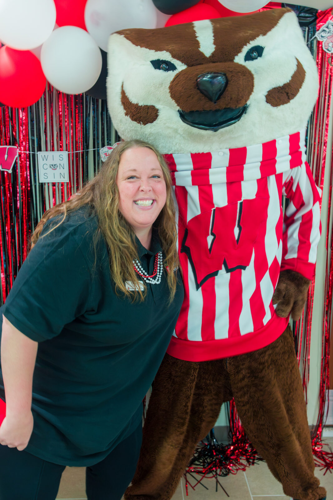 Bucky Badger poses with a Residence Life Coordinator