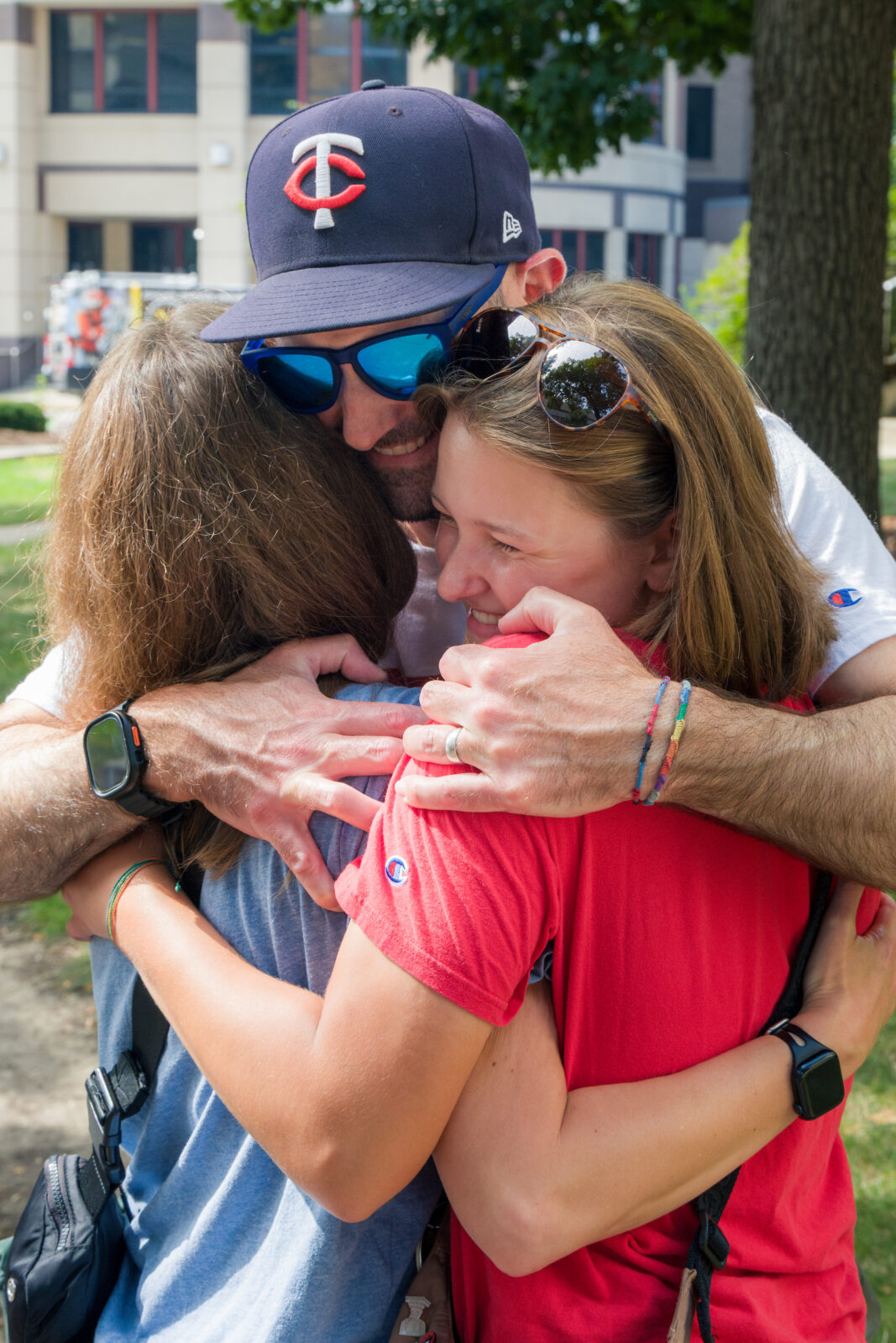 Two parents hugging their child
