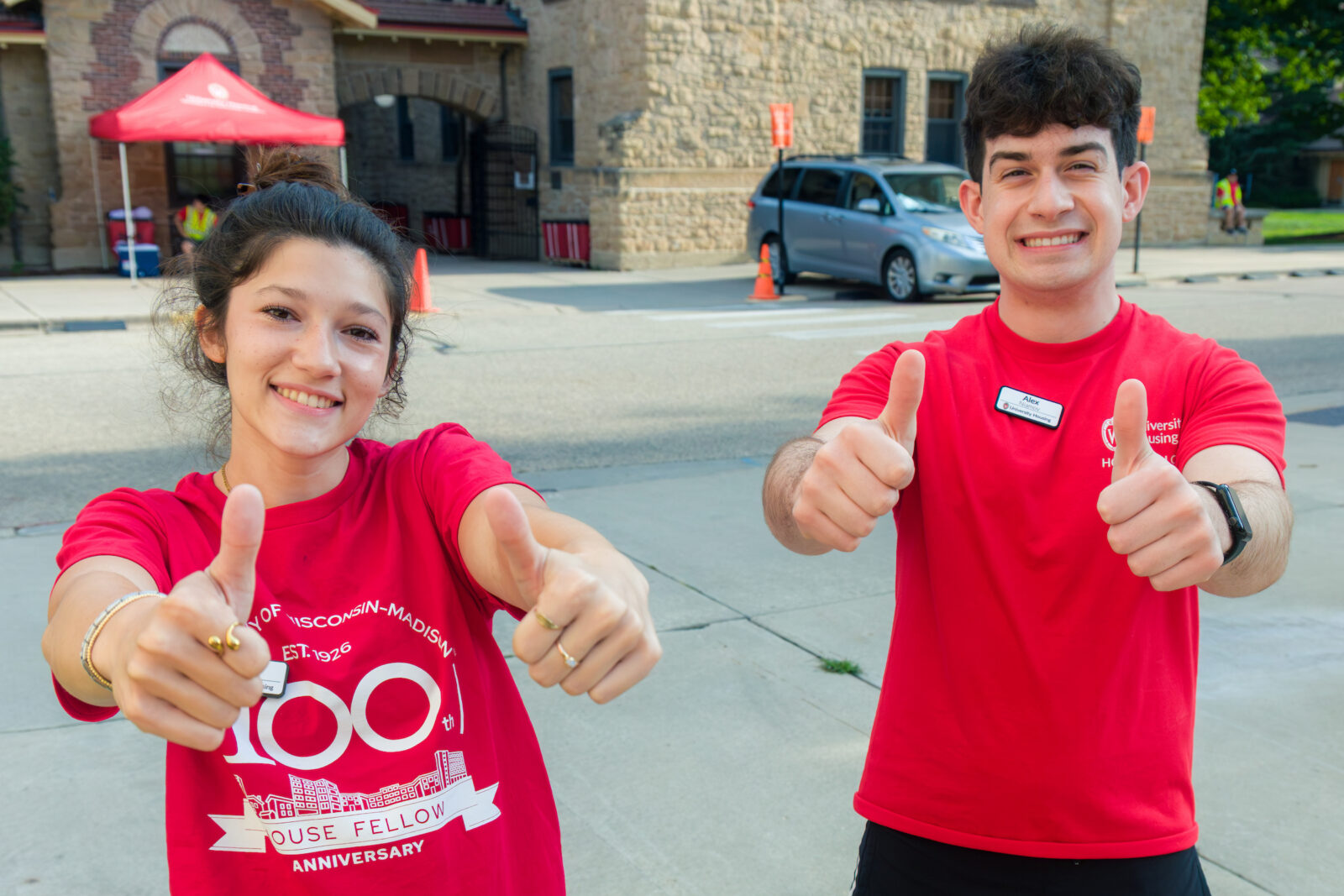 Two House Fellows give the thumbs up sign to the camera