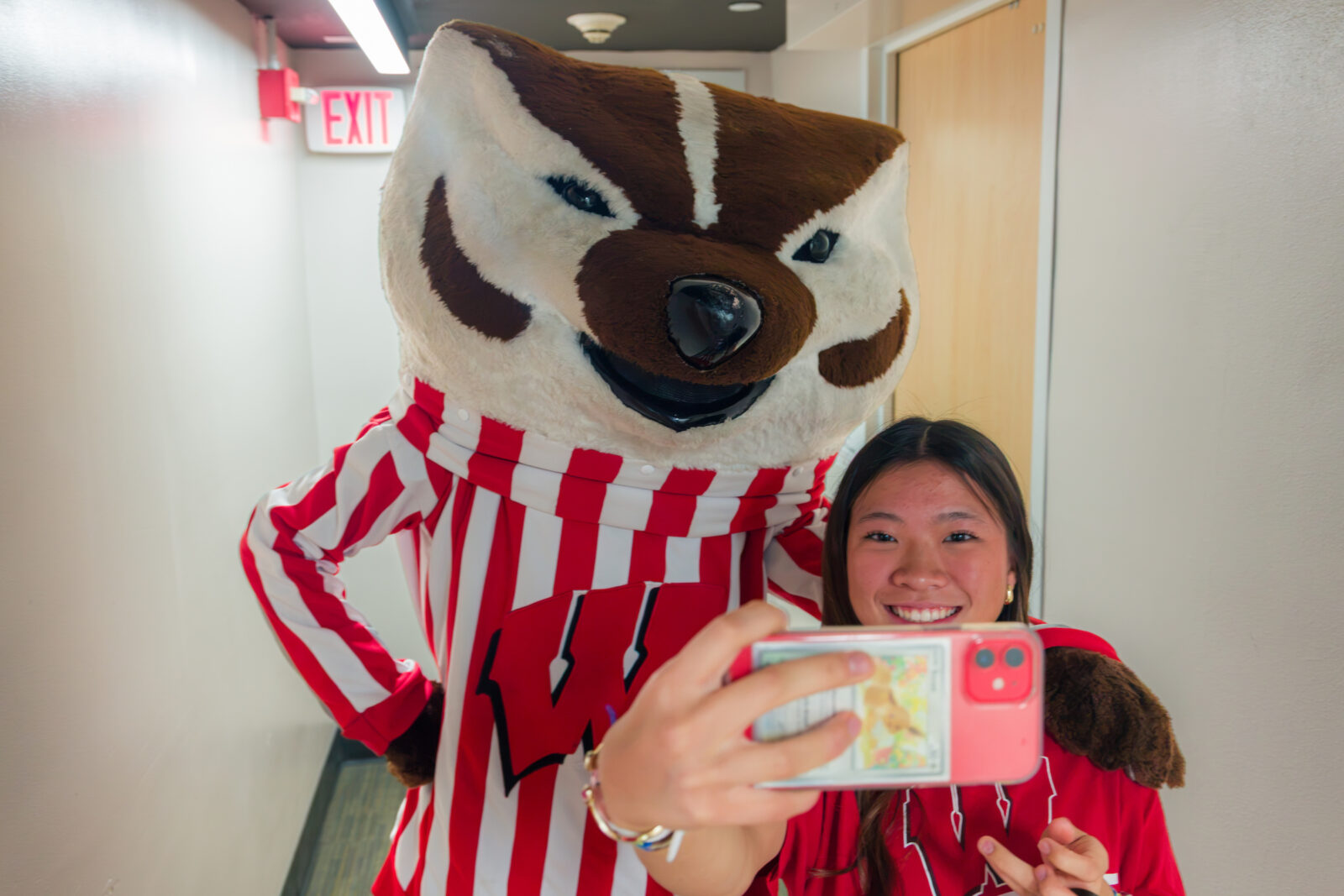 A student takes a selfie with Bucky Badger