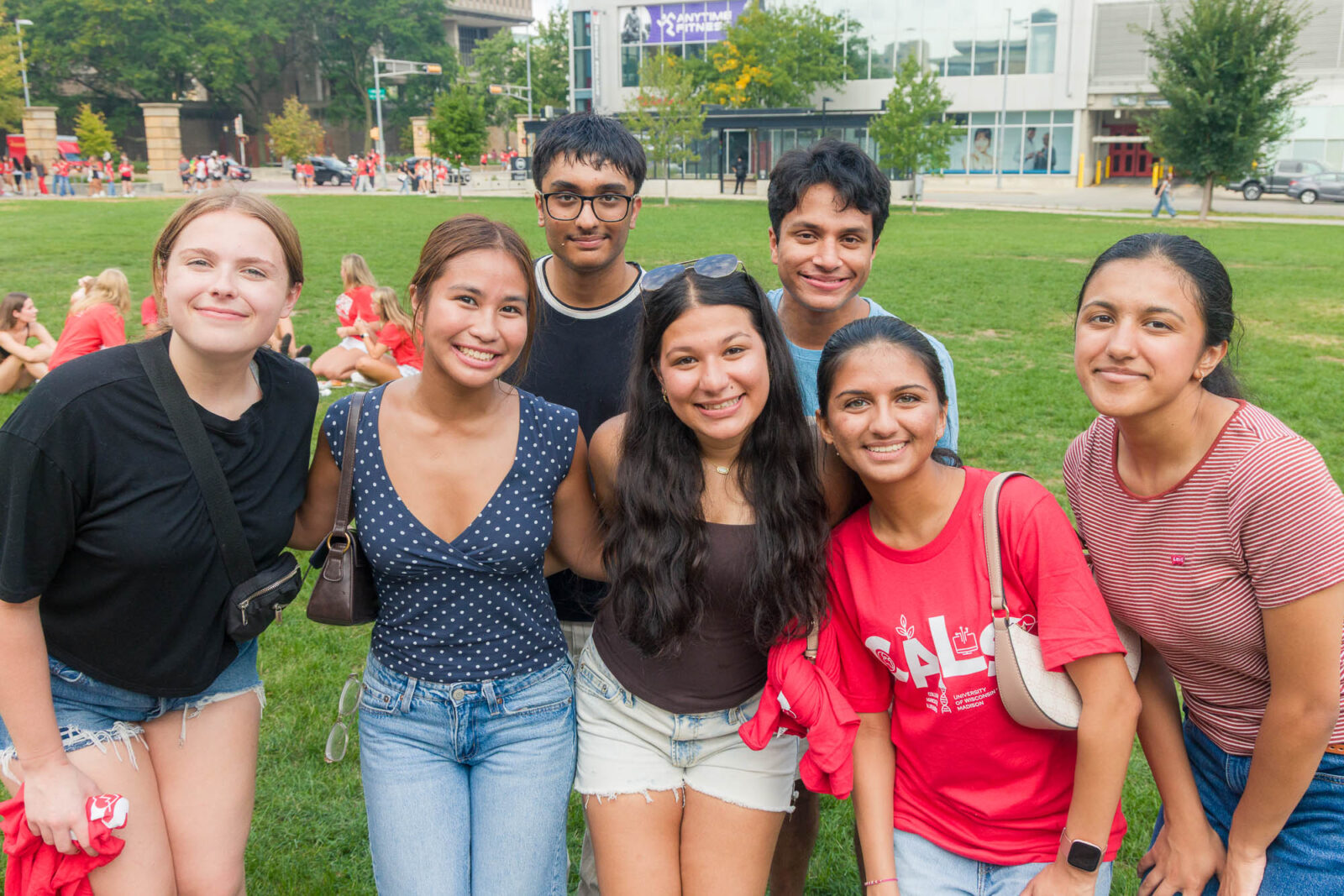 Seven people smile for a photo