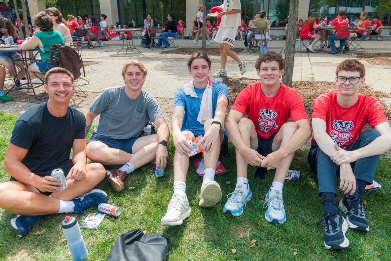 Five students pose for photo sitting on Gordon lawn during Convocation Lunch