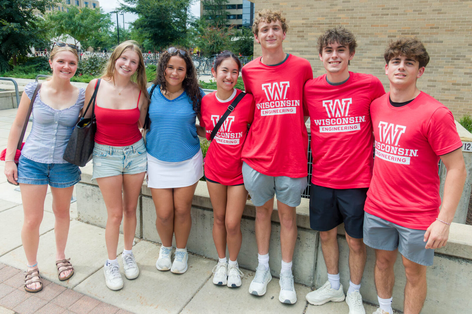 Seven people posing while standing